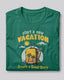 Green t-shirt with travel-themed design and text on a light gray background