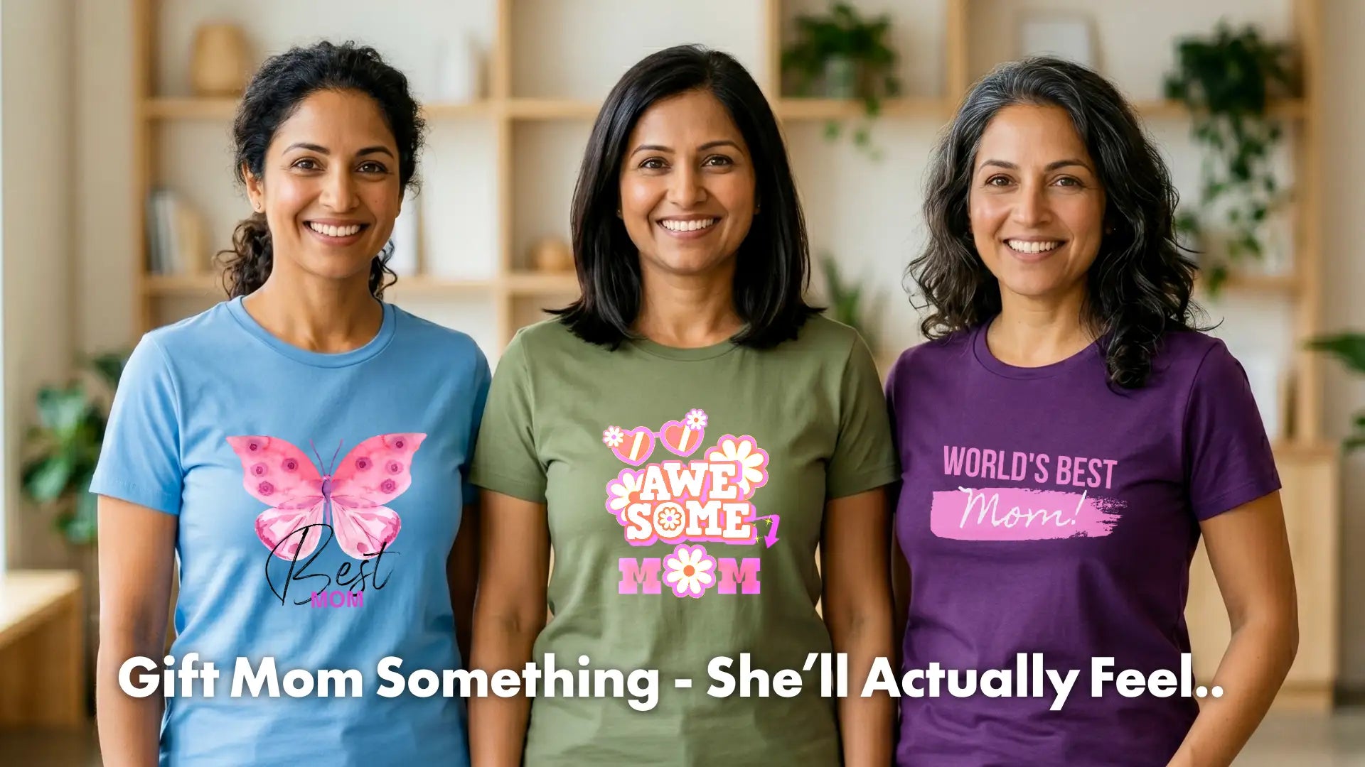 Three women wearing Mother's Day-themed t-shirts in a casual indoor setting.