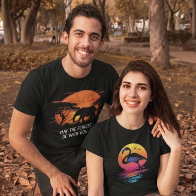 Two people wearing black t-shirts with nature-themed designs and quotes, standing in a natural setting with trees and animals.